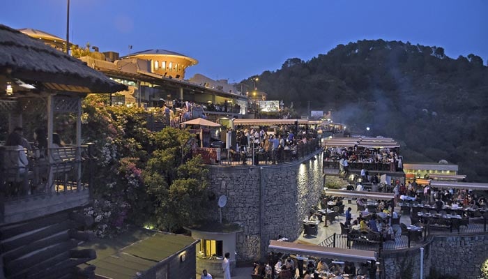 People can be seen at a restaurant at Margalla Hills in Islamabad, on June 20, 2021. — Online/File