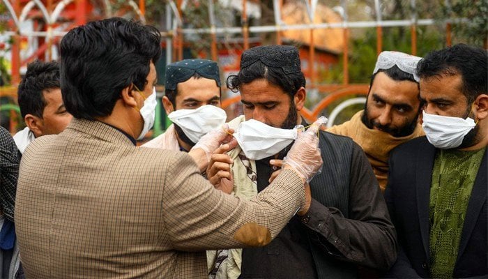 A man teaches how to wear a mask properly. Photo: Files