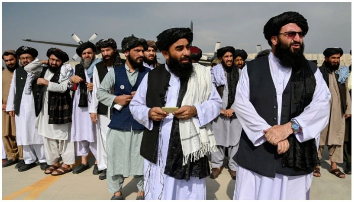 Taliban officials stand on the tarmac of Kabul airport after the withdrawal of US troops from Afghanistan. — AFP