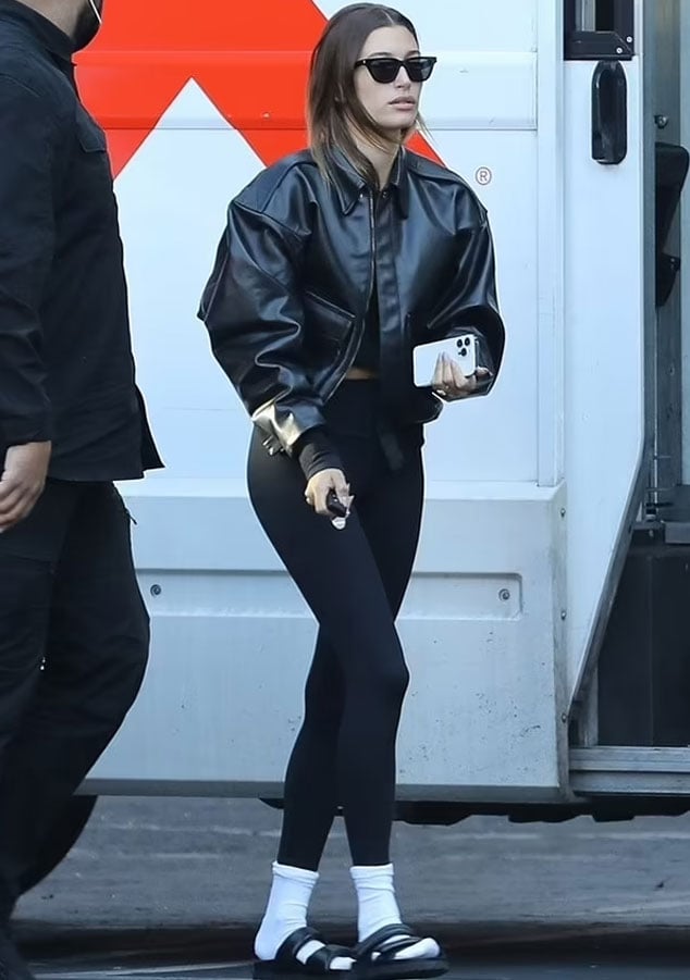 Hailey Bieber shows off her model legs in a pair of clinging black leggings