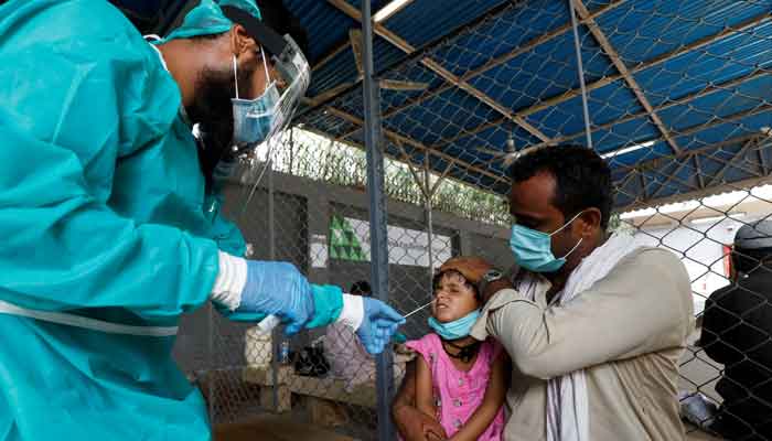 A healthcare worker collecting sample for COVID-19 test. File photo