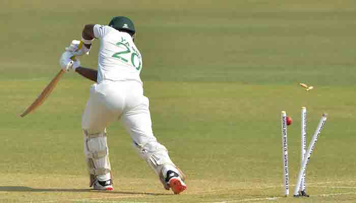 Debutant Yasir Ali loses his stumps to Hasan Ali during the first Test against Pakistan. -AFP