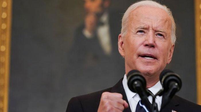 Biden reassures Americans they need not panic over Omicron