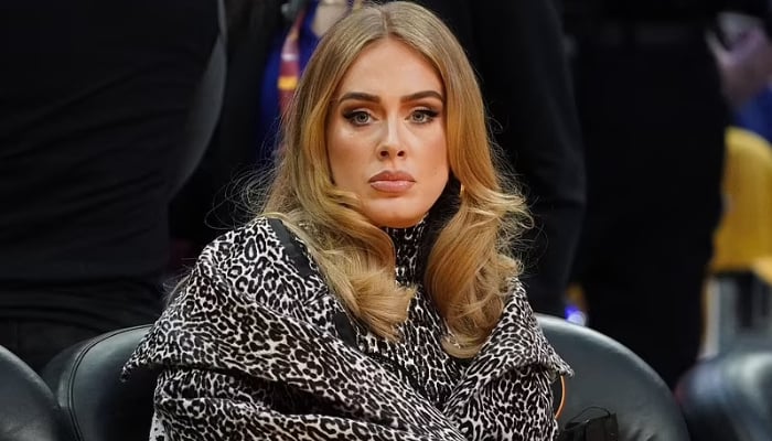 Adele ditches diamond ring for simple band in recent outing, looks ‘glum’