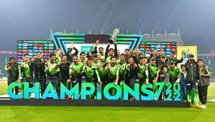 Lahore Qalandars players pose with the trophy after winning the final of the Pakistan Super League (PSL) Twenty20 cricket match against Multan Sultans at the Gaddafi Cricket Stadium in Lahore on February 27, 2022. -PCB