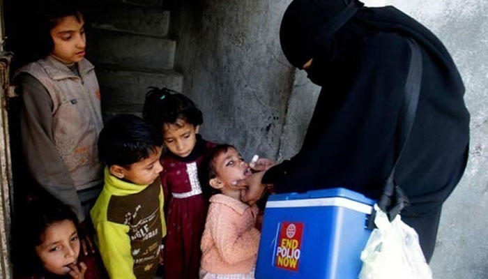 A health worker administers polio drops to children. — AFP/File