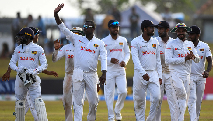 Sri Lankas players walk back to the pavilion at the end of the second day play of the second cricket Test match between Sri Lanka and Pakistan at the Galle International Cricket Stadium in Galle on July 25, 2022. -AFP