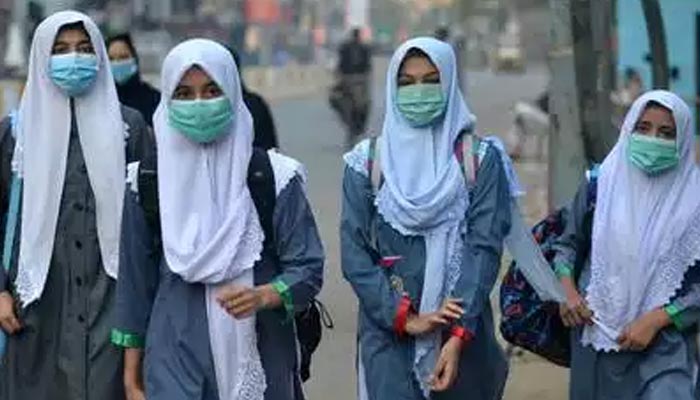 Girls walk to school. — AFP/File