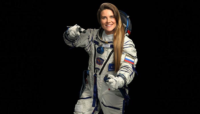 This undated handout photograph released by the Russian Space Agency Roscosmos on August 26, 2022, shows female cosmonaut Anna Kikina posing for a picture in a space suit in Moscow.