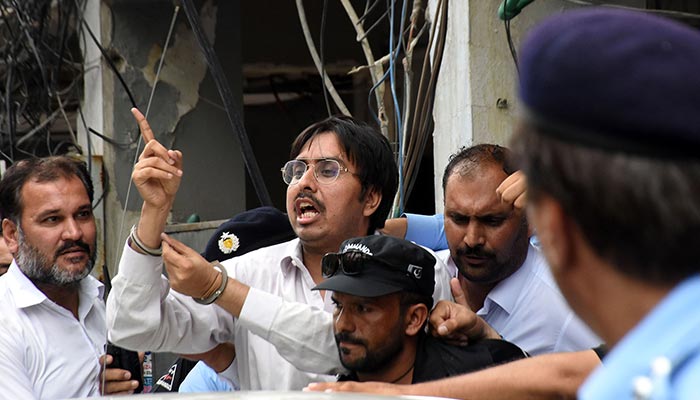 Police officers escort the leader of Pakistan Tehreek-e-Insaaf (PTI) Doctor Shahbaz Gill after a hearing at district court, in Federal Capital. — Online