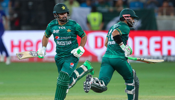 Pakistans Khushdil Shah (L) and Mohammad Rizwan take a run during the Asia Cup Twenty20 international cricket Group A match between India and Pakistan at the Dubai International Cricket Stadium in Dubai on August 28, 2022. -AFP