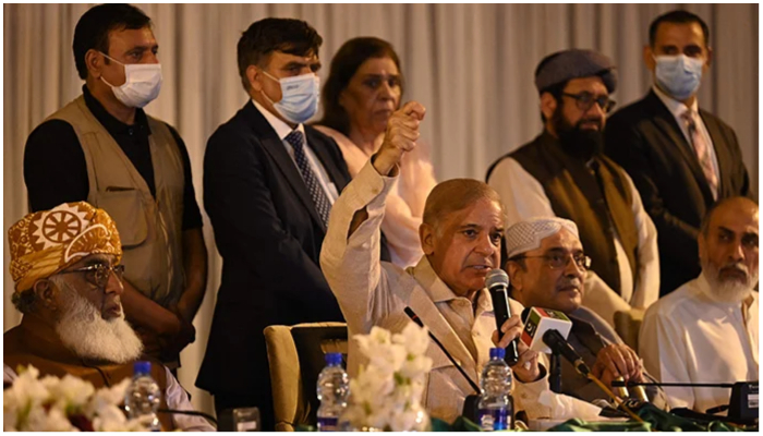 Prime Minister Shehbaz Sharif (centre) and PPP Co-chairman Asif Ali Zardari (second right) speak during a press conference in Islamabad on March 28, 2022. — AFP