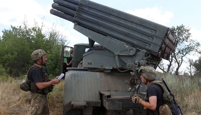 Ukrainian servicemen prepare to fire a Grad BM-21 multiple rocket launcher at the front line between Russian and Ukraine forces in the countryside of the eastern Ukrainian region of Donbas on July 19, 2022 amid the Russian invasion of Ukraine. — AFP