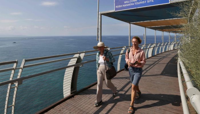 In this file photo taken on October 7, 2022, tourists walk in a viewing post overlooking the Mediterranean Sea in Israel´s Rosh Hanikra, at the border area with Lebanon.— AFP