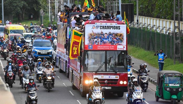 Members of the Sri Lankan cricket team travel on an open-top bus to celebrate their victory during the Asia Cup Twenty20 tournament in Dubai, after returning to Colombo on September 13, 2022. — AFP