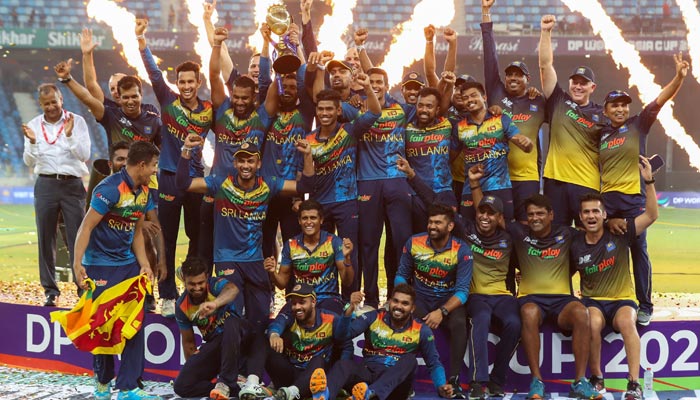 Sri Lankas team members celebrate with the trophy at the end of the Asia Cup T20 international cricket final match between Pakistan and Sri Lanka at the Dubai International Cricket Stadium in Dubai on September 11, 2022. — AFP