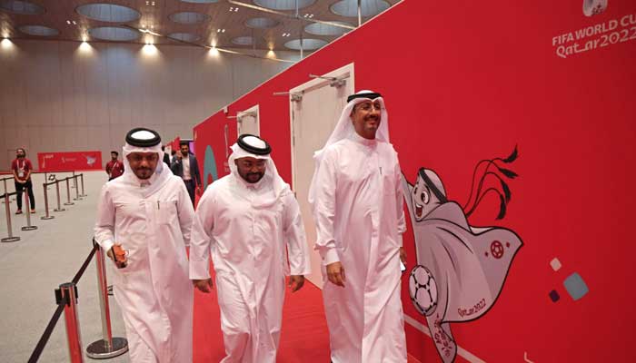 Saad al-Suwaidi (C), head of the Hayya pass service, walks at the service centre which assists fans attending this year´s Qatar FIFA World Cup, in the capital Doha on October 16, 2022. — AFP