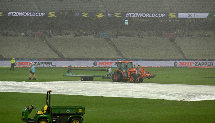 Ground staff cover the field as rain delays the start of play during the ICC mens T20 World Cup 2022 cricket match between New Zealand and Afghanistan and Ireland at Melbourne Cricket Ground (MCG) on October 26, 2022 in Melbourne. — AFP/File