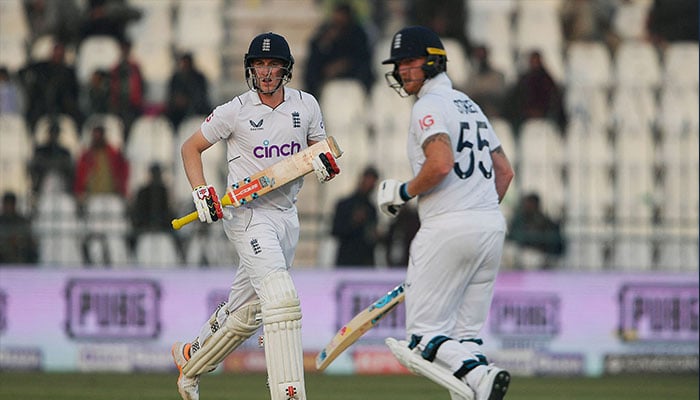 England´s Harry Brook (L) and captain Ben Stokes run between the wicket during the second day of second Test in Multan Cricket Stadium on December 10, 2022. — AFP