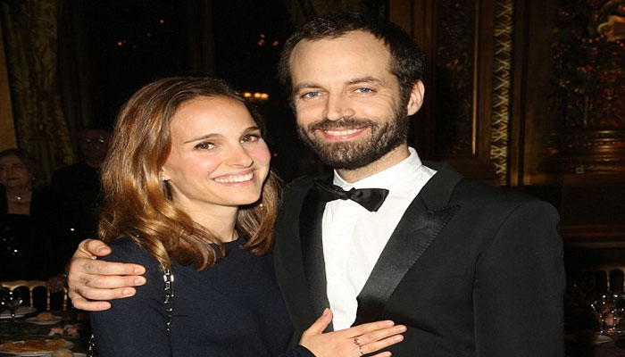 Natalie Portman in high sprits as she snuggles up to husband Benjamin Millepied