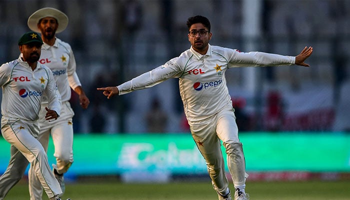 Pakistan´s Abrar Ahmed (R) celebrates after taking wicket of England´s Zak Crawley (not pictured) during the first day of the third cricket Test match between Pakistan and England at the National Stadium in Karachi on December 17, 2022. — AFP