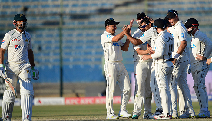 New Zealands players celebrate after the dismissal of Pakistans Shan Masood (L) during the fourth day of the first Test match between Pakistan and New Zealand at the National Stadium in Karachi on December 29, 2022. — AFP