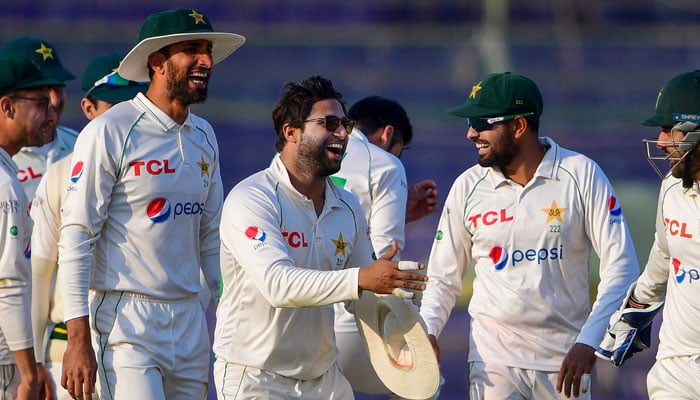 Pakistans players celebrate after the dismissal of New Zealands Henry Nicholls (not pictured) during the first day of the second cricket Test match between Pakistan and New Zealand at the National Stadium in Karachi on January 2, 2023. — AFP