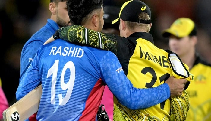 Australias David Warner (right) embraces Afghanistans Rashid Khan. – AFP