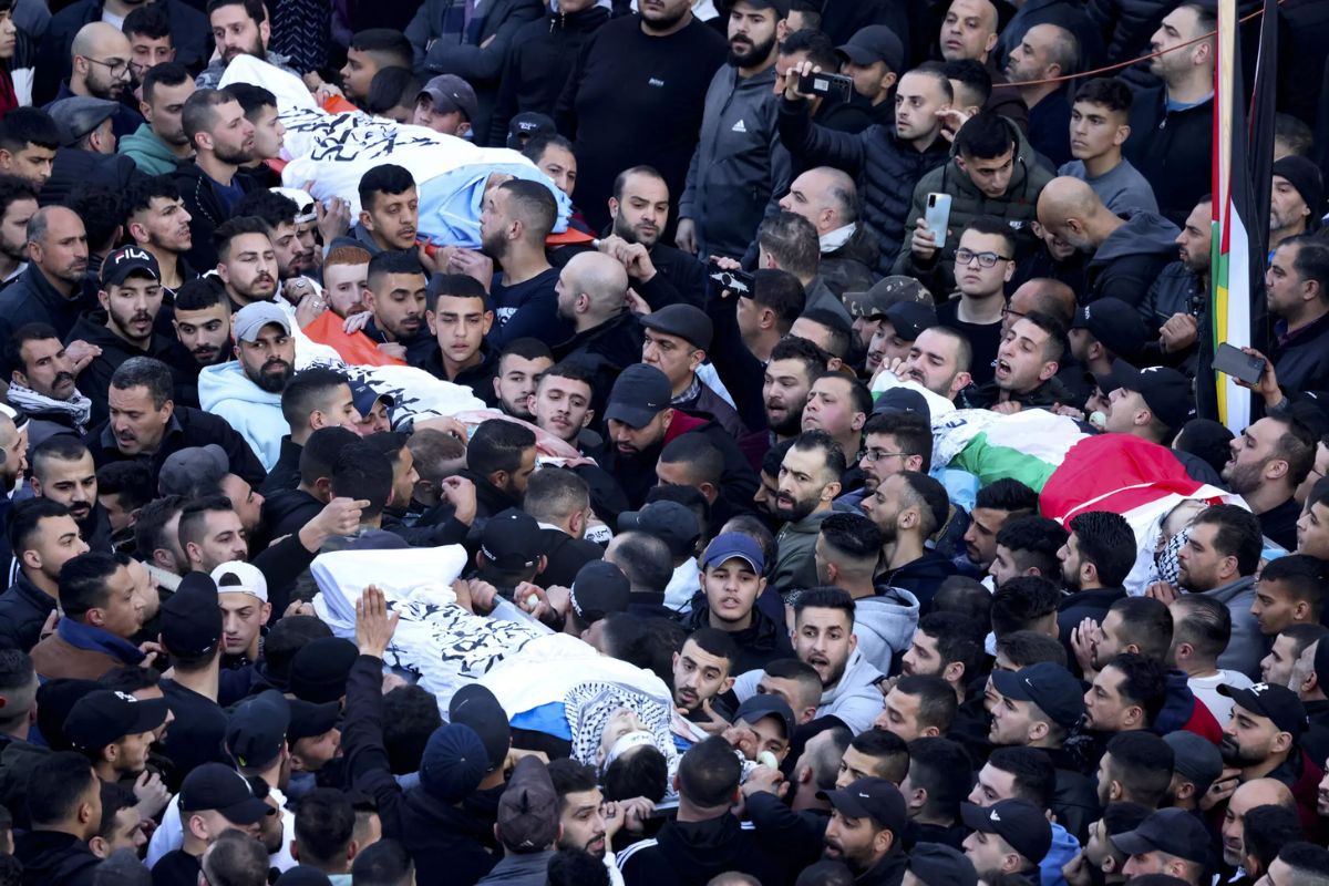 Mourners carry bodies of Palestinians martyred in a raid by Israeli forces on the occupied West Bank city of Nablus.— AFP