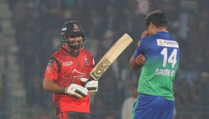 Lahore Qalandars batter grins while a Multan Sultans player looks disappointed during the first match of the Pakistan Super League (PSL) at the Multan Cricket Stadium in Multan on February 13, 2023. — PSL