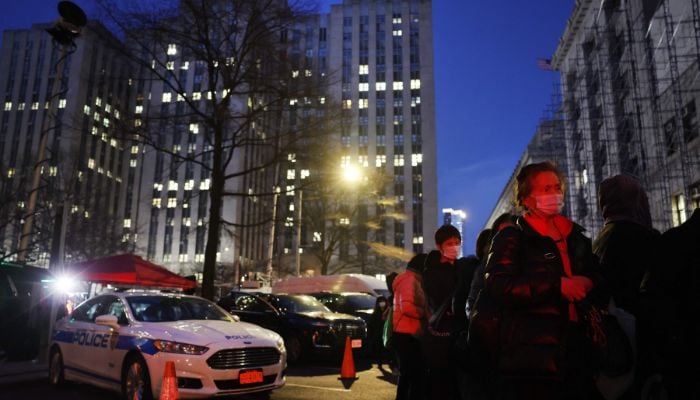 People line up for a meal outside of Manhattan Criminal Courthouse on April 03, 2023 in New York City.— AFP