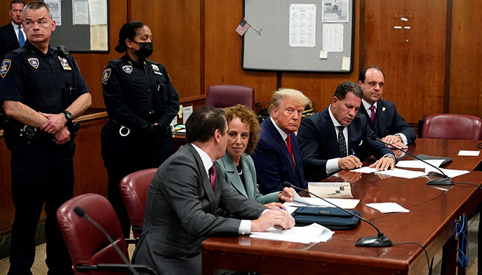 Former US president Donald Trump looks on as he appears in court at the Manhattan Criminal Court in New York on April 4, 2023. AFP