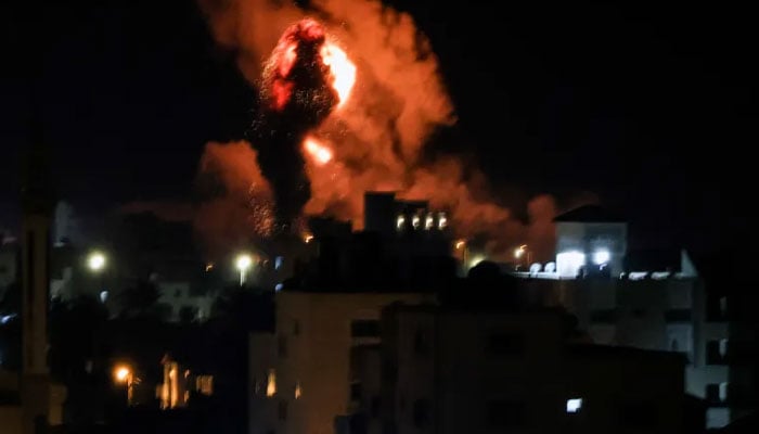 Fire and smoke rise above buildings in Gaza City on Monday morning following Israeli air raids. AFP/File