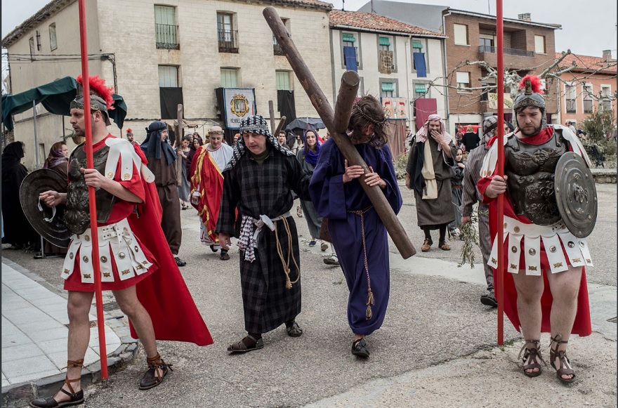 An actor portraying Jesus carries a cross as residents of Hiendelaencia dressed in period clothing perform during the reenactment of Christ’s suffering on March 25, 2016 in Hiendelaencina, Spain.— AFP