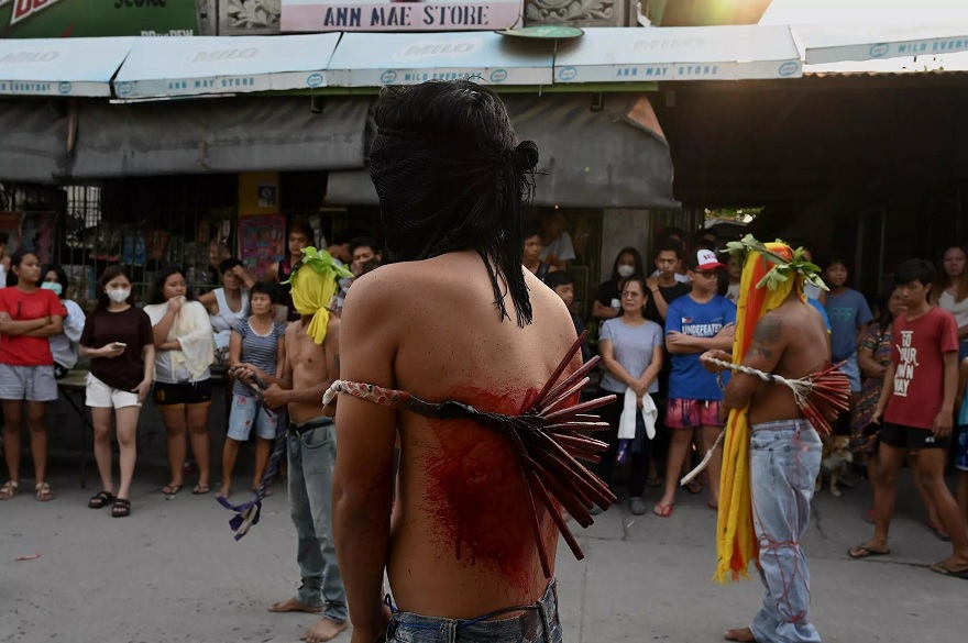 Penitents flagellate themselves on Good Friday as part of Holy Week celebrations in the Philippines.— AFP