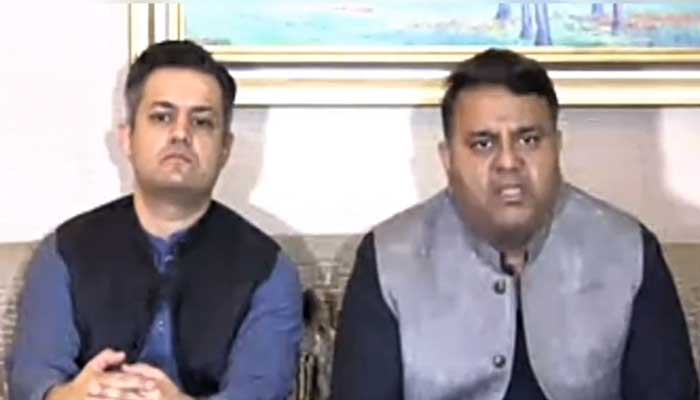 PTI leaders Hammad Azhar (left) and Fawad Chaudhry address a press conference in Lahore on April 8, 2023, in this still from a video. — Twitter/@PTIofficial