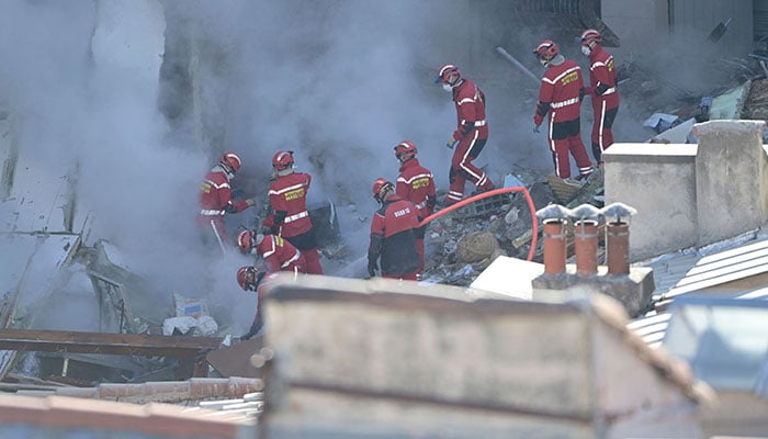 Firefighters work at ´rue Tivoli´ after a building collapsed in the street, in Marseille, southern France, on April 9, 2023. AFP