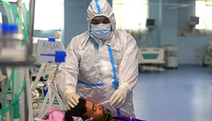 Health workers take part in a mock drill to check preparations for the COVID-19 coronavirus facilities at a hospital in Prayagraj on April 11, 2023. — AFP