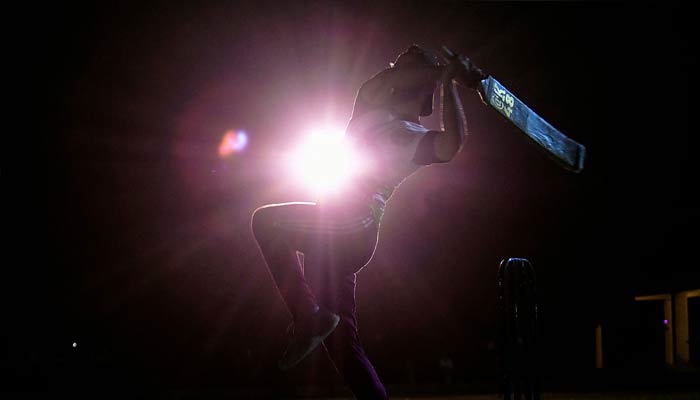 A plays a shot during a nighttime cricket tournament during the month of Ramadan in Karachi on April 7, 2023. — AFP