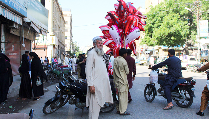 A balloon seller can be seen outside a mosque after Eid ul Fitr prayers in Karachi's Saddar area, on April 22, 2023. — Hassaan Ahmed