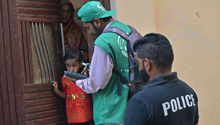 An official from the Pakistan Bureau of Statistics (PBS) collects information from a resident during the seventh population census in Karachi on March 1, 2023. — AFP/File