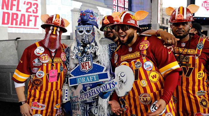 Chicago Bears and Carolina Panthers fans pose for a photo as they