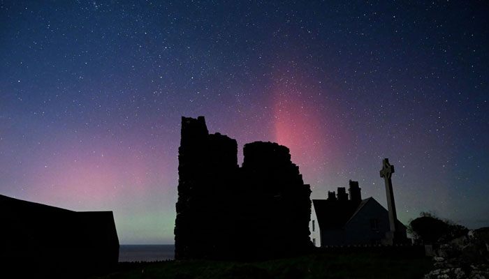 The picture shows the Aurora Borealis above buildings on Ynys Enlli, known as Bardsey Island in English, an island off of the west coast of Wales, southwest of Pwllheli. — AFP/File