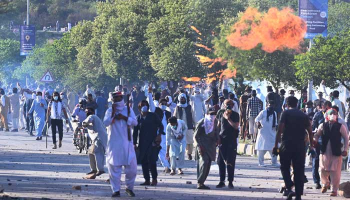 PTI party activists and supporters of former Pakistan´s Prime Minister Imran clash with police during a protest outside the police headquarter where Khan was in custody, in Islamabad on May 10, 2023. — AFP