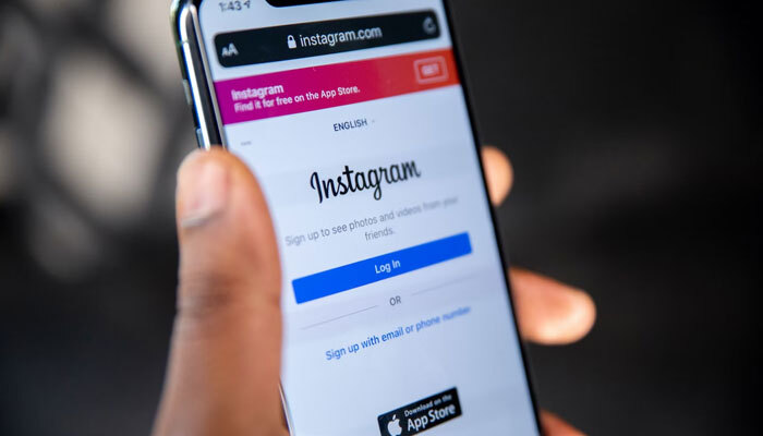 This picture shows the homepage for Instagram displayed on a smartphone. — Unsplash