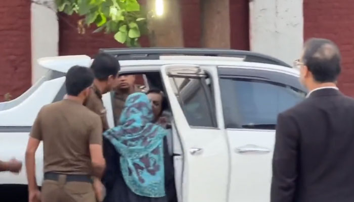 Police officials arrest Pakistan Tehreek-e-Insaf leader Dr Shireen Mazari from outside the Adiala jail on May 22, 2023, in this still taken from a video. — Twitter/ @MehwishQamas