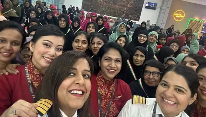 Pilots, crew members and passengers of a women-only Hajj flight pose for a photo before departing from Kozhikode on June 8. — Air India