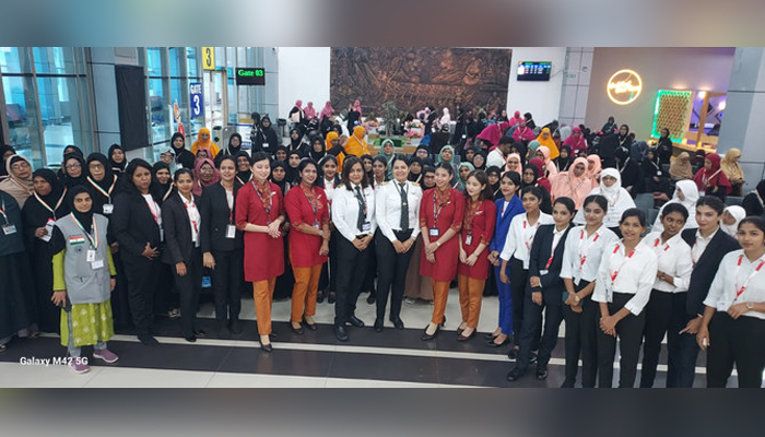 Pilots, crew members and passengers of a women-only Hajj flight pose for a photo before departing from Kozhikode on June 8. — Air India