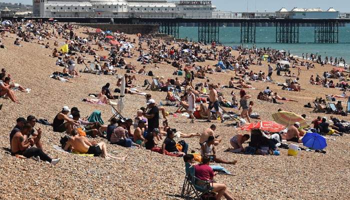 This representational picture shows people hanging out at the beach on a sunny day in Scotland. — AFP/File