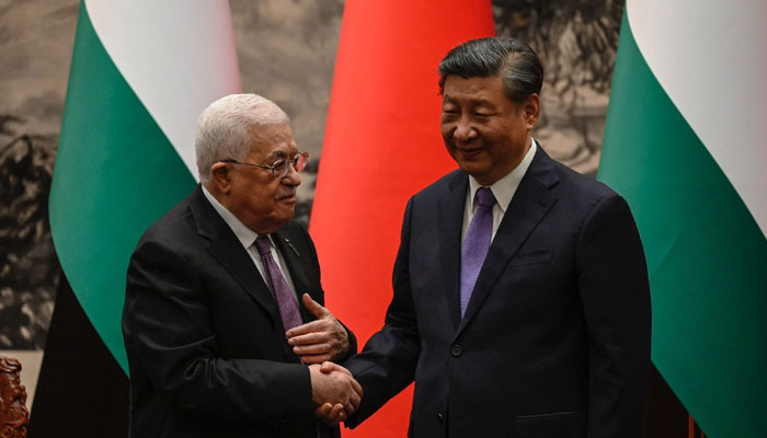 Palestinian President Mahmud Abbas (Left) shakes hands with Chinas President Xi Jinping after a signing ceremony at the Great Hall of the People in Beijing on June 14, 2023. — AFP